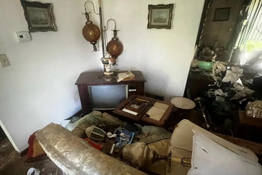 Cluttered living room full of old furniture before a estate cleanout by ONIT Junk Removal