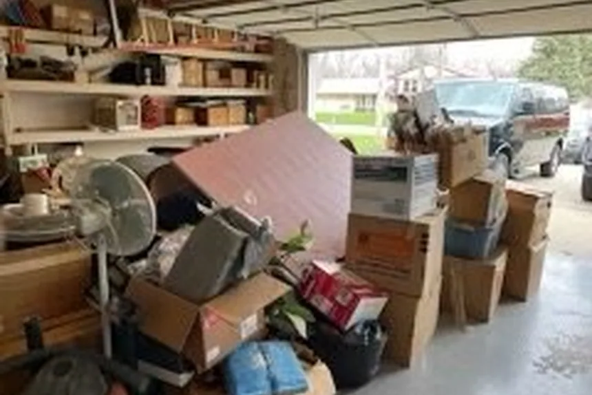 Cluttered garage full of boxes before a cleanout by ONIT Junk Removal