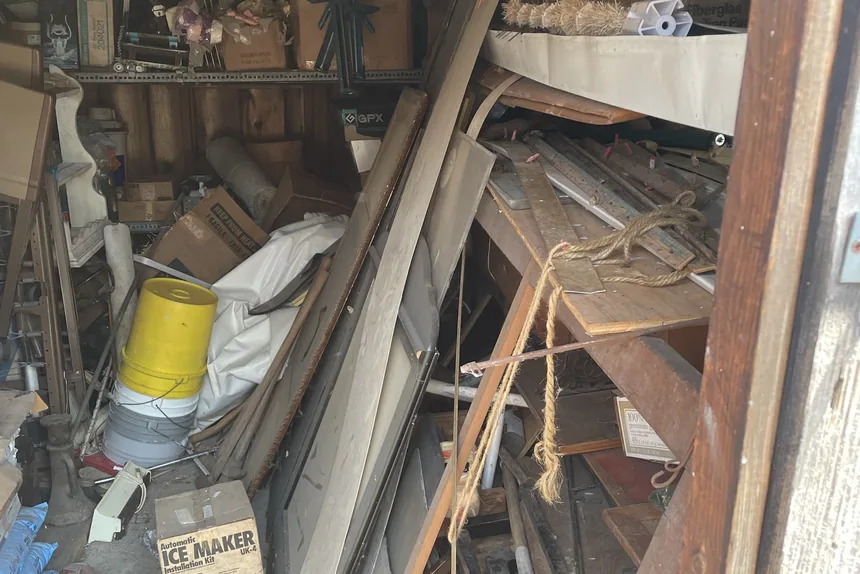Packed cluttered garage interior before a garage cleanout in Crest Hill, IL by ONIT Junk Removal