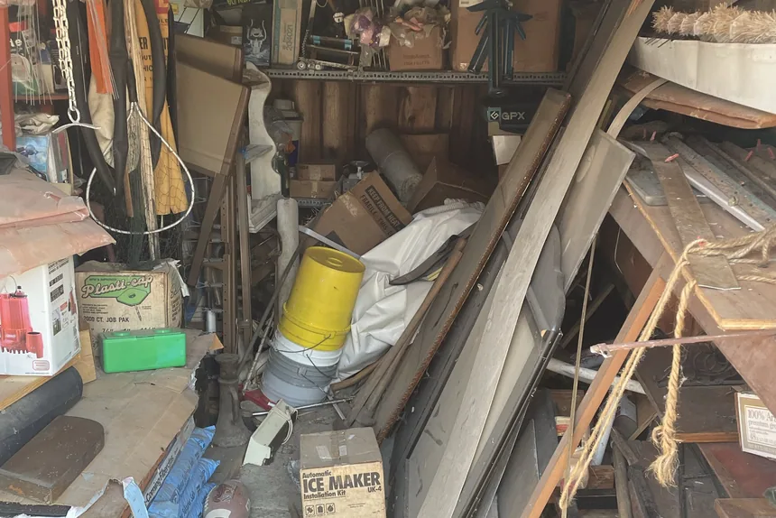 Cluttered garage full of debris before a garage cleanout in Crest Hill, IL by ONIT Junk Removal