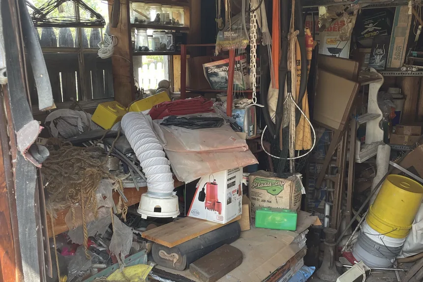 Cluttered packed wooden shed interior before a garage cleanout in Crest Hill, IL by ONIT Junk Removal