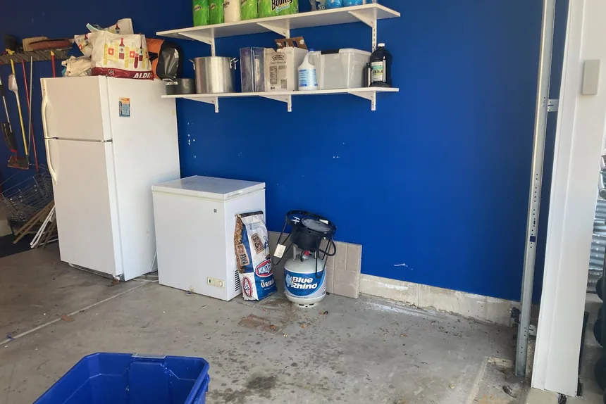Old fridge and freezer removed from a garage by ONIT Junk Removal