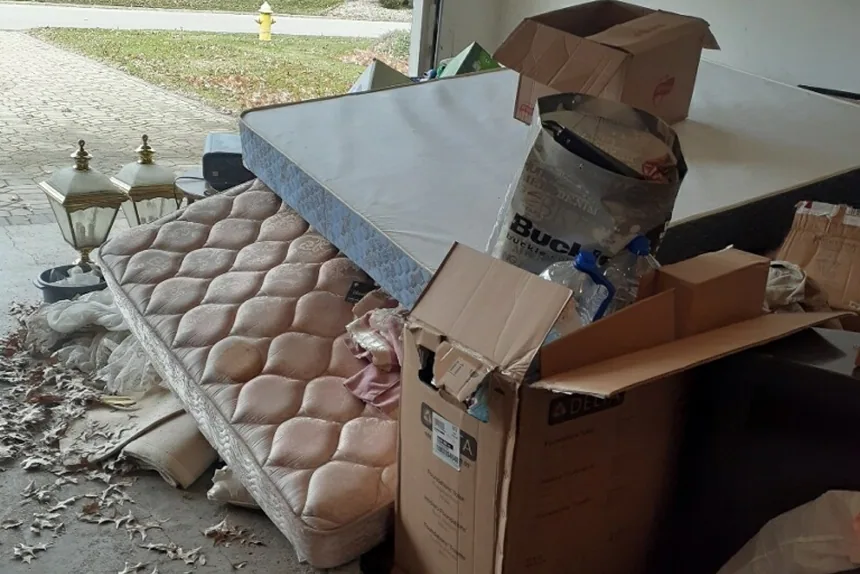 Old mattresses and boxes cleared from a garage by ONIT Junk Removal