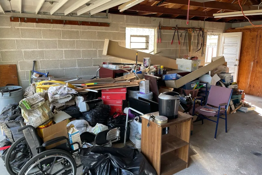 Packed two-car garage before a cleanout by ONIT Junk Removal