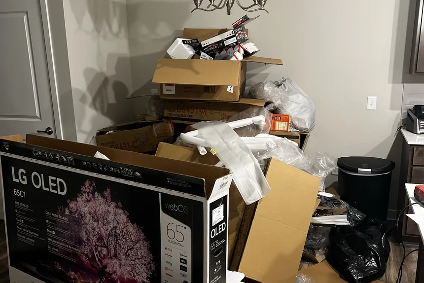 Pile of moving boxes and a large tv carton before junk removal by ONIT Junk Removal