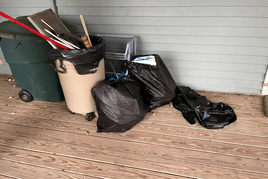 Trash bags and bin on deck by ONIT Junk Removal
