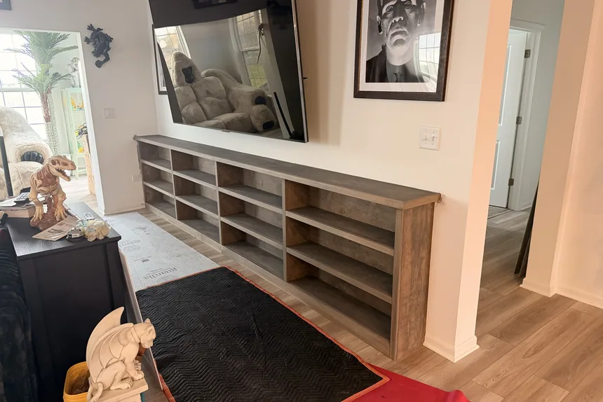 Empty built-in shelving unit in living room by ONIT Junk Removal