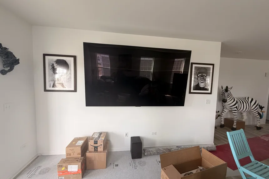 Living room with boxes and wall tv before a property cleanout by ONIT Junk Removal