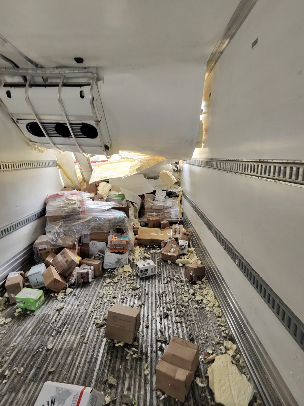 Semi reefer trailer before cleanout, collapsed load, spilled freight and packaging debris