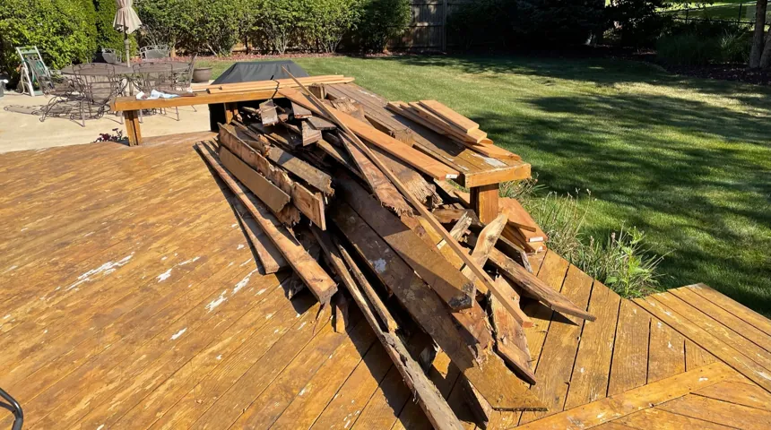 Torn-out deck boards and framing stacked for demo debris removal in Mokena, IL by Onit Junk Removal